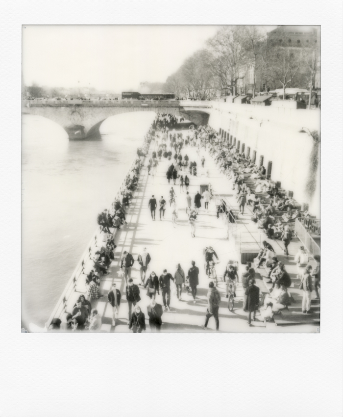 Black and white Polaroid of Paris. Crowd strolling along the quays of the Seine on a spring weekend before the 3rd confinement. Paris on 13 March 2021. Photo by Virginie Merle / Hans Lucas. 
Foule en balade sur les quais de Seine un week-end de printemps avant le 3 -eme confinement. Paris le 13 Mars 2021. Photo de Virginie Merle / Hans Lucas.