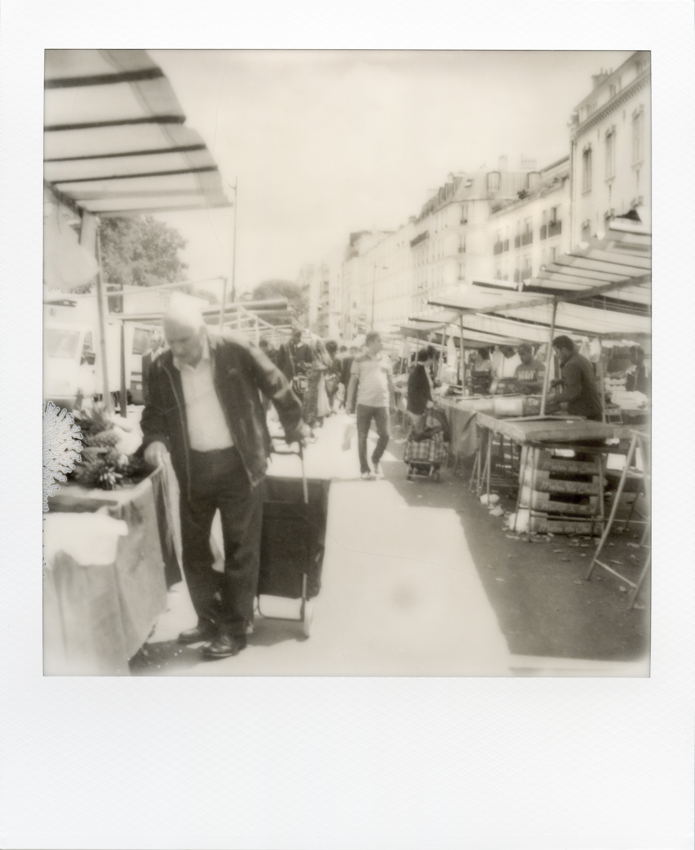 Black and white Polaroid from Paris. Belleville market.Paris, 26 June 2018. Photo by Virginie Merle / Hans Lucas. 
Polaroid noir et blanc de Paris. Marche de Belleville. Paris le 26 Juin 2018. Photo de Virginie Merle / Hans Lucas.